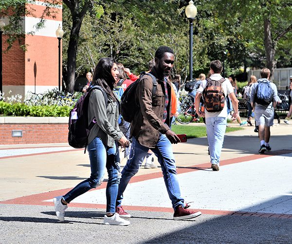 Students walking across a college campus