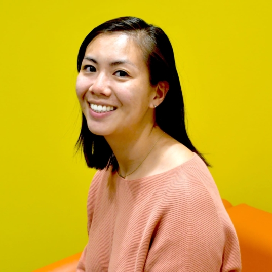 photo of Katherine Wiryaman smiling in front of a yellow background