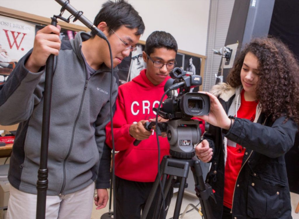 Group of high school students working with cameras