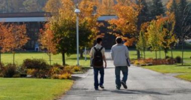 Two male students walking on a college campus