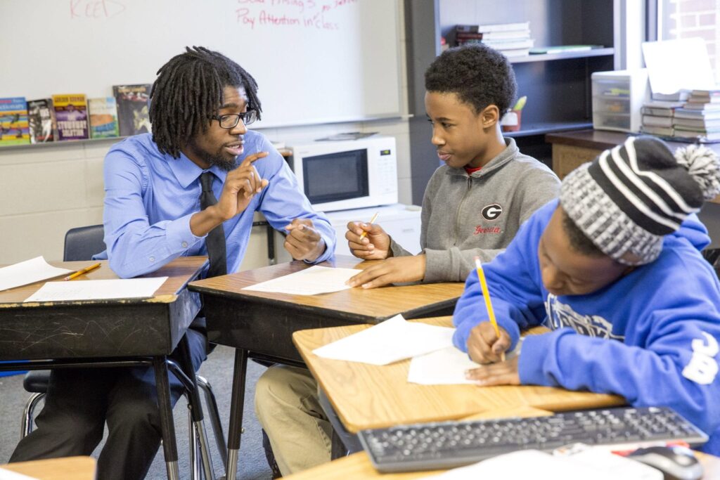 Mansur Ali Buffins coaches 6th grader Cordarious Williams on setting goals at Clarke Middle School. Photo by Dorothy Kozlowski