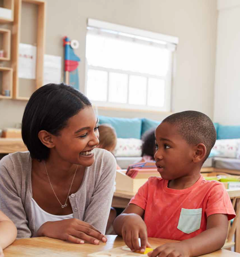 Black teacher and young black male student