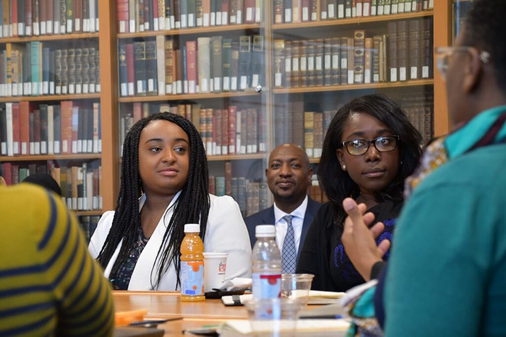 Two female African American students sitting in a library