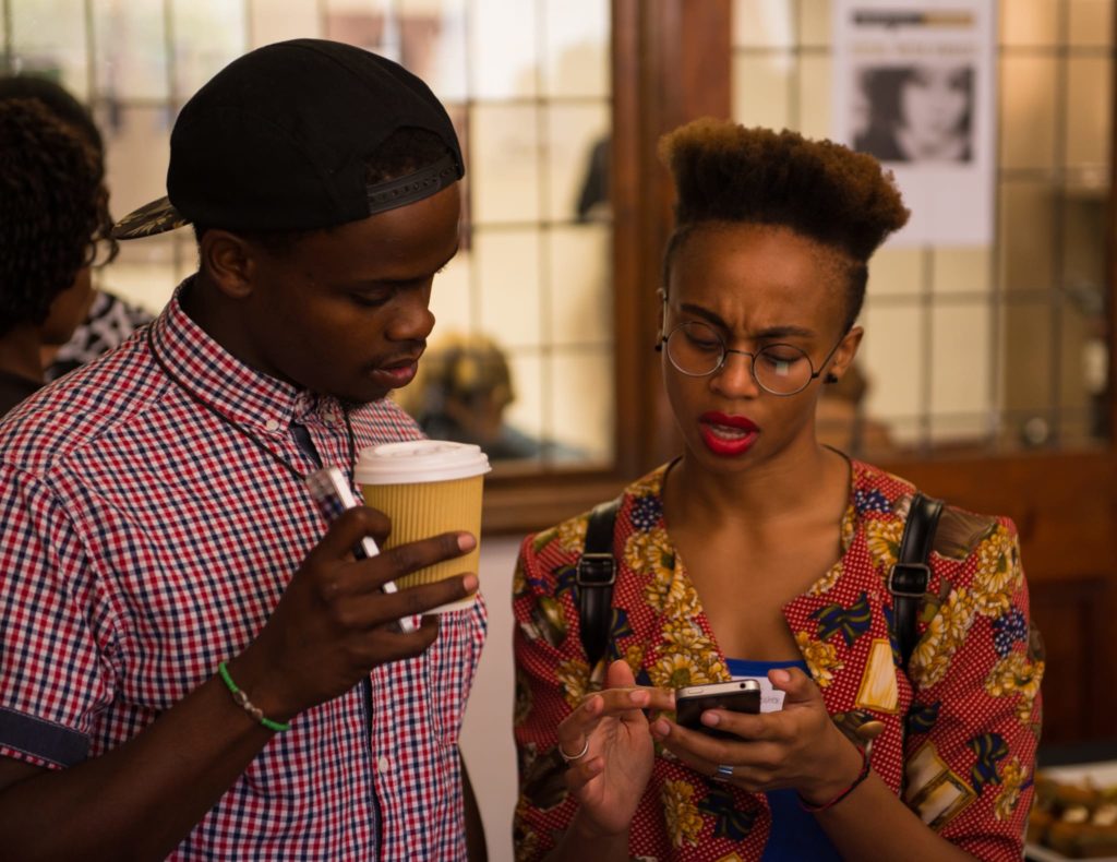 Black male and female looking at cellphone