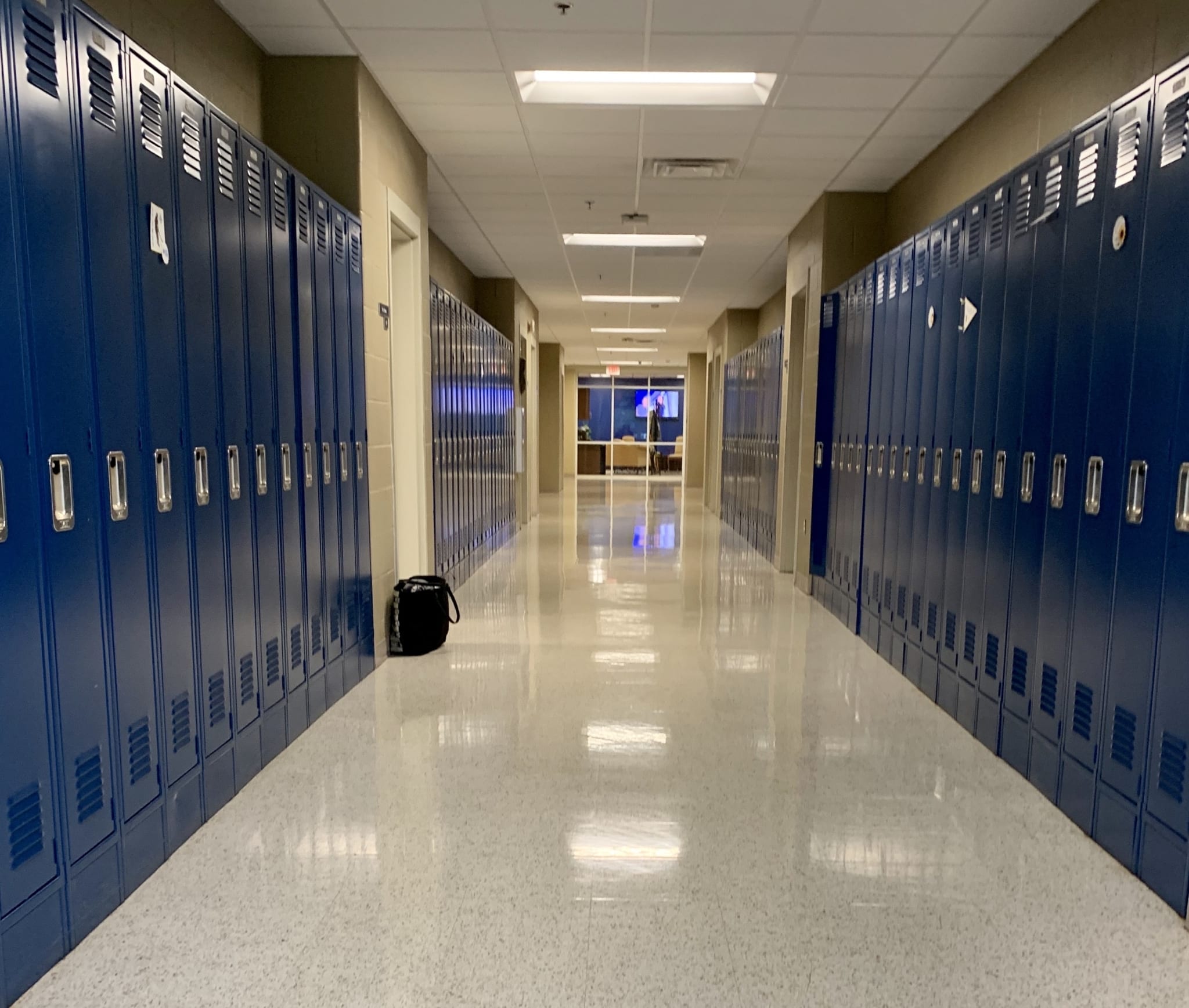 Empty school hallway with blue lockers