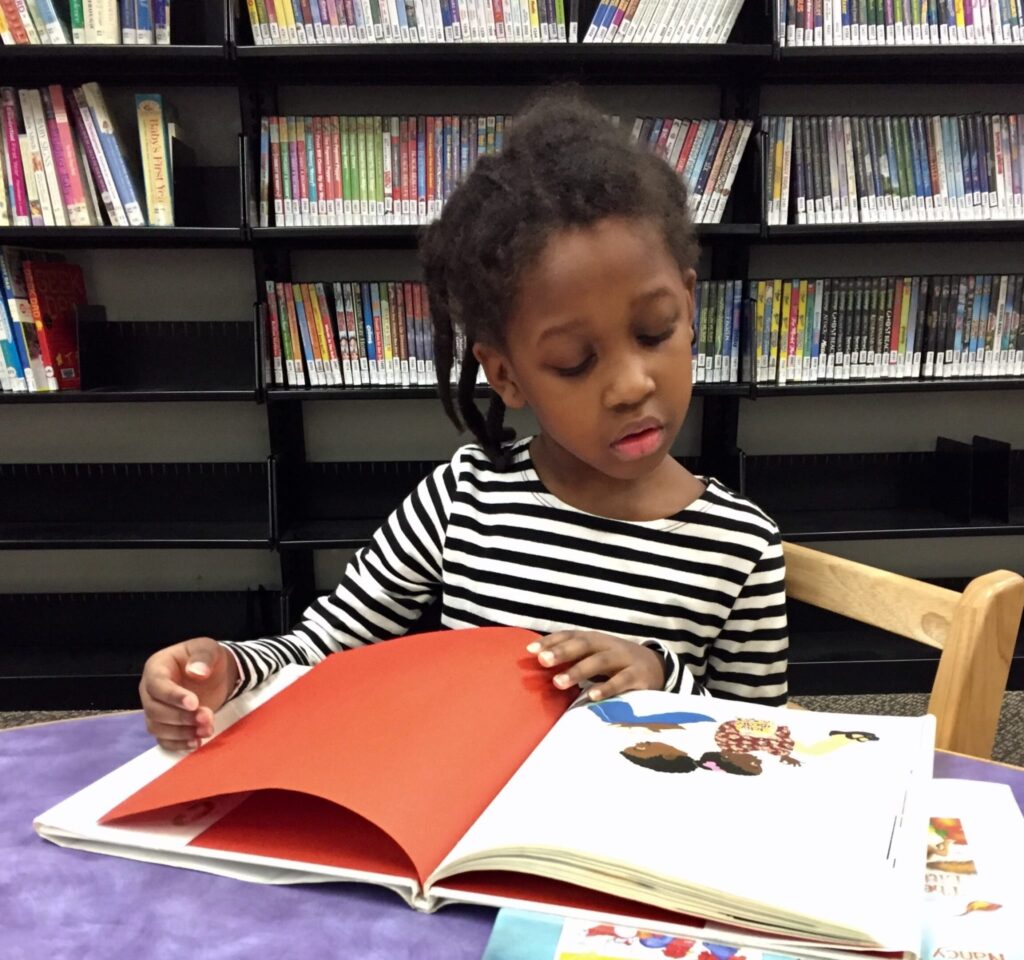 young girl reading a book