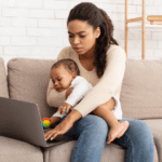 Parent with Child Trying to Work on a Laptop