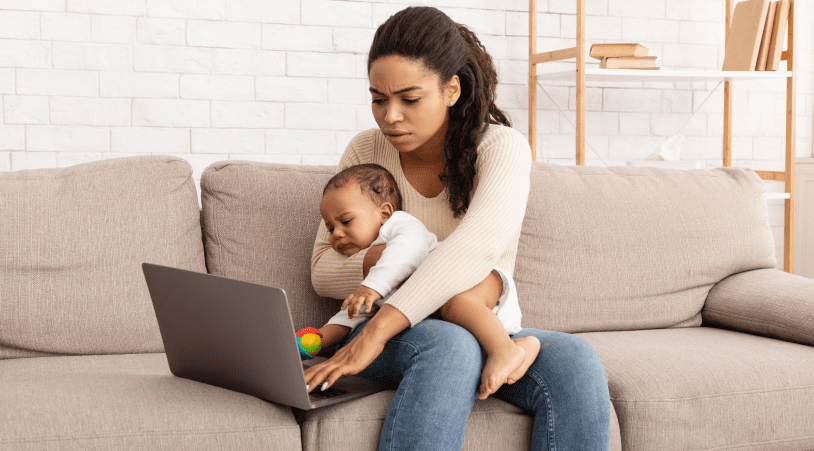 Parent with Child Trying to Work on a Laptop