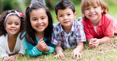 four Latino kids smiling