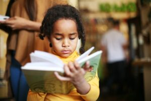 Black girl reading a children's book