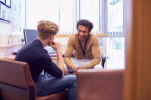 Principal and student sitting in a school office