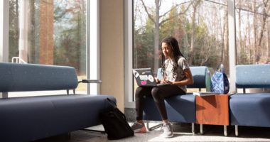 Female student studying in lobby