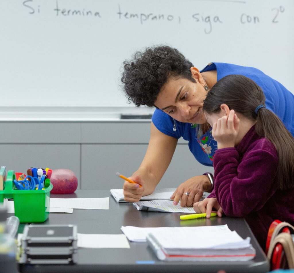 Female elementary teacher with female student