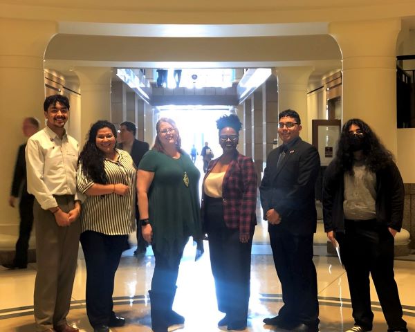 Six young people standing at the hallway of a state capitol