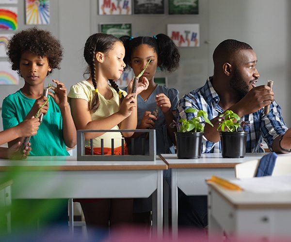 Students in science class with a male teacher