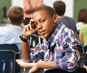 a young black male student in a classroom