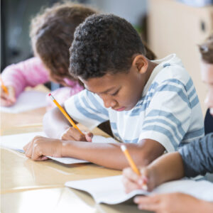 young students sitting at a desk studying