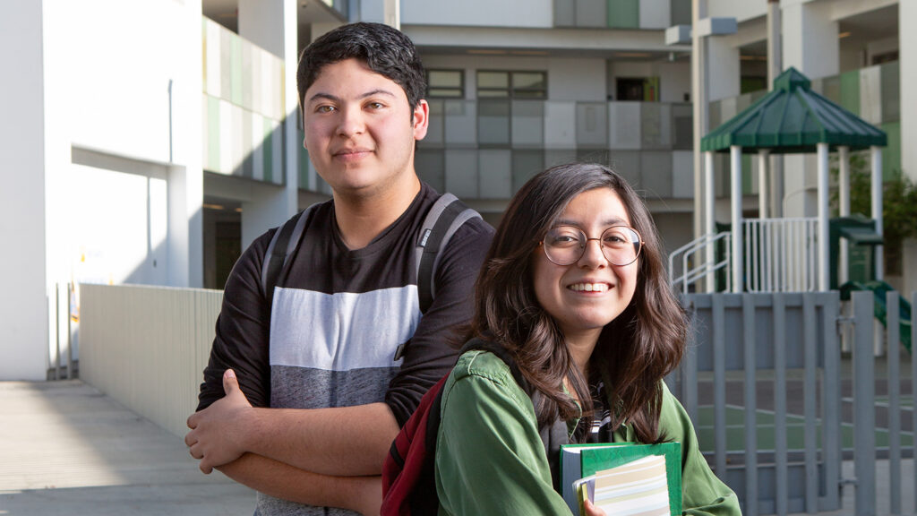 Two high school students pose for a portrait between classes.