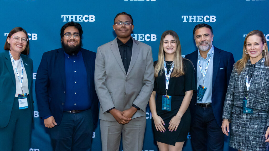 A multiethnic group of people in business clothing standing for the camera