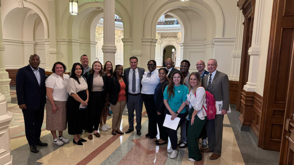 A group of people posing for the camera in the Texas state capitol
