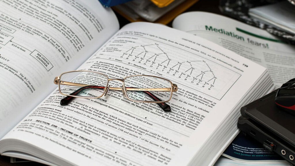 close up of eyeglasses sitting on top of a math book