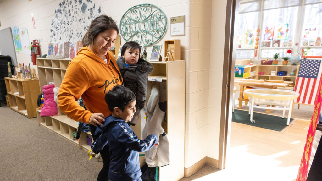 Mother dropping a young boy in the early morning at a child care center on a college campus